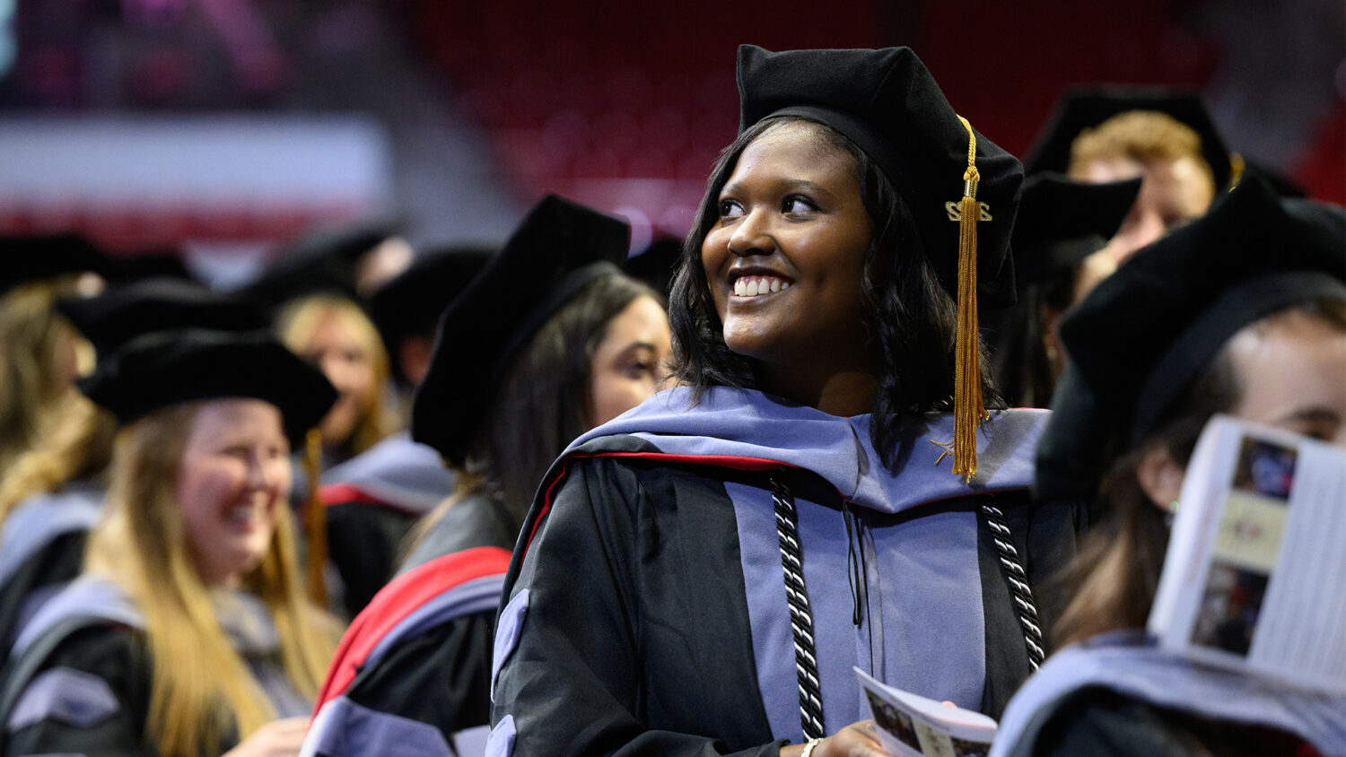 A new graduate at her Oath and Hooding ceremony.